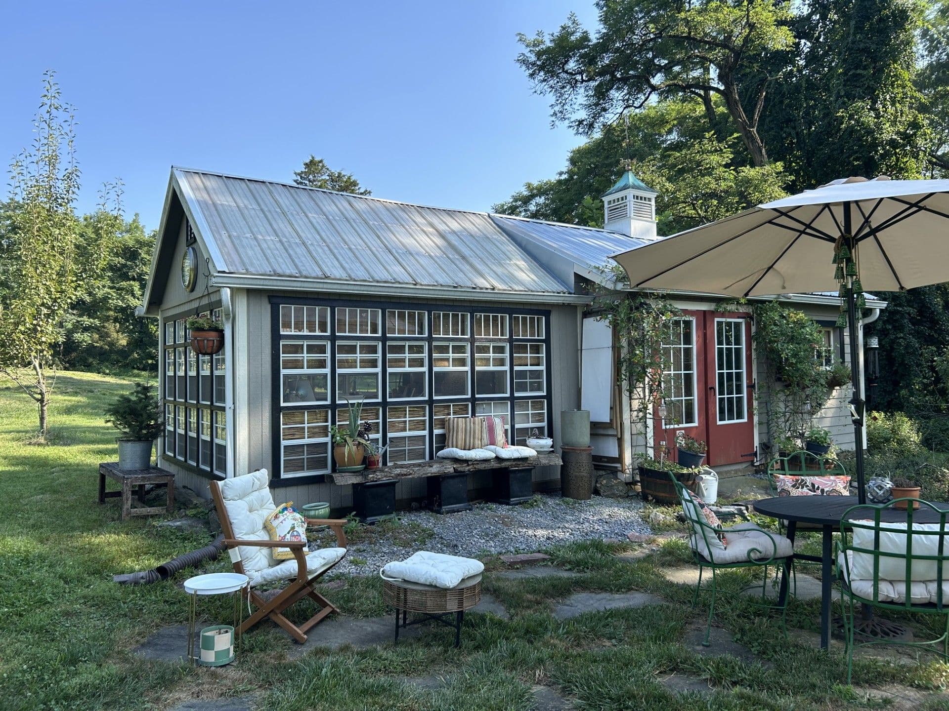 wood greenhouse attached to shed with cupola