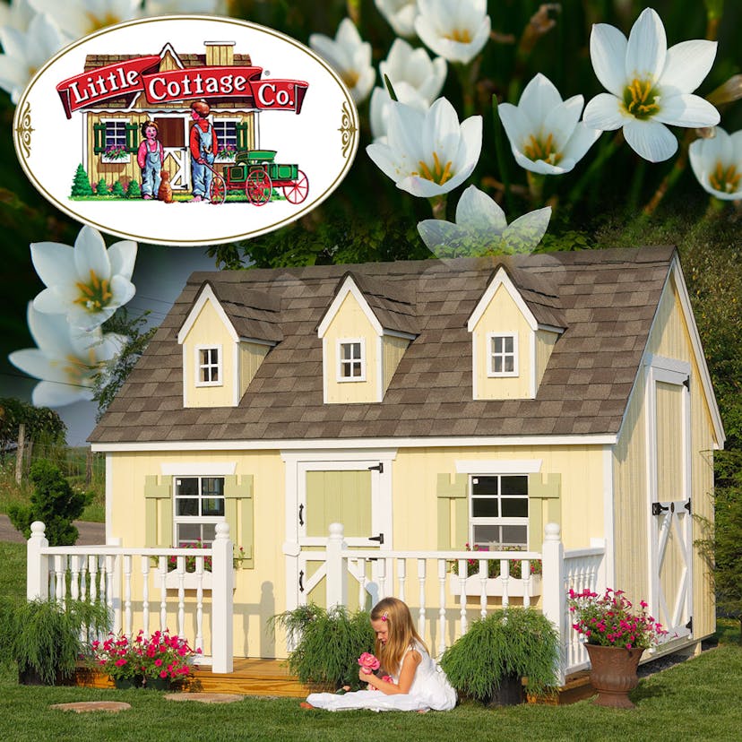 Yellow Cape Cod Playhouse in backyard with girl playing dolls in front. Background of white flowers.