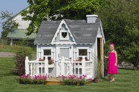 4x6 Victorian Playhouse with deck and rail and child opening door